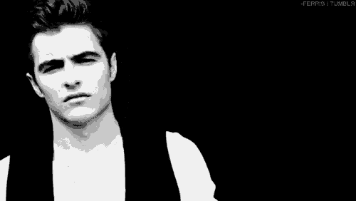 a man in a white shirt and black vest is making a funny face in a black and white photo .