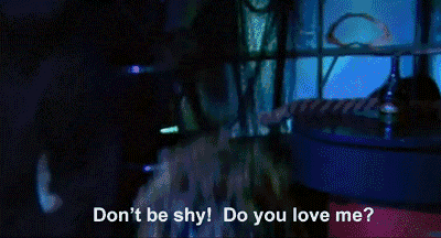 a man in a blue jacket and tie is saying do you love me