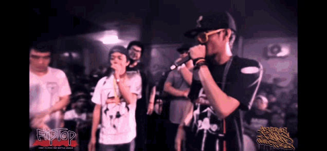 a man singing into a microphone in front of a crowd with the word hiptop on the bottom