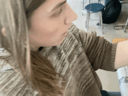 a close up of a woman 's face in a room