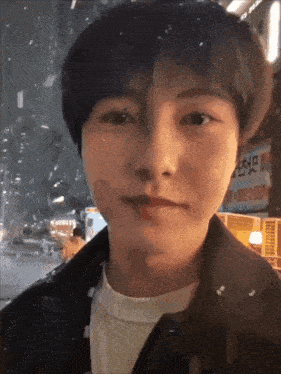 a close up of a person 's face with a sign in the background that says ' a '