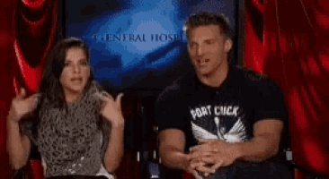 a man and woman are sitting in front of a screen that says general host