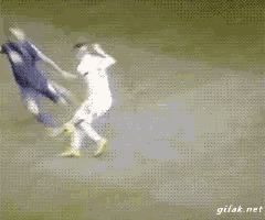 a soccer player is being tackled by another player and the gif is from gifak.net
