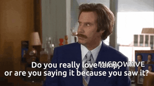 a man with a mustache in a suit and tie says do you really love microwave or are you saying it because you saw it