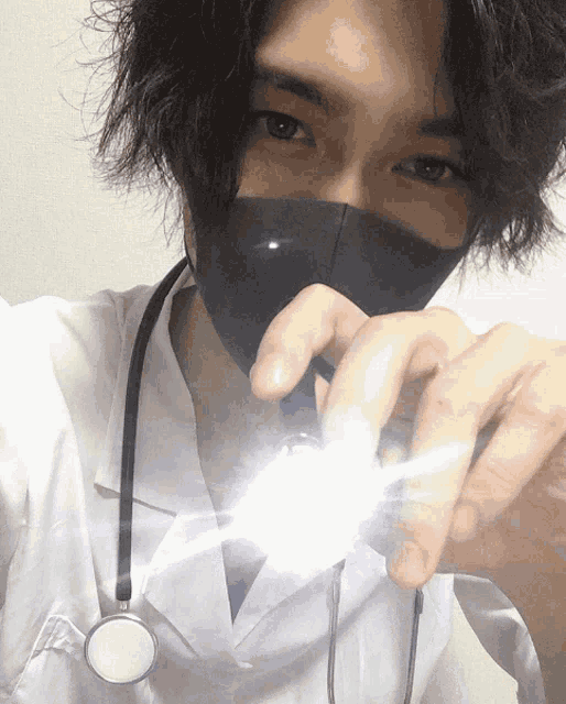 a man wearing a mask and a stethoscope taking a picture of himself