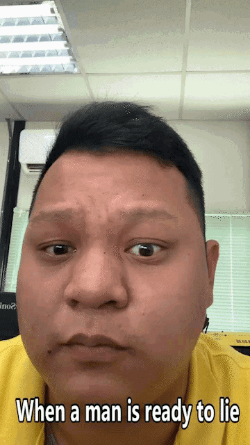 a man in a yellow shirt is ready to lie