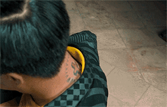 a person with a tattoo on their neck that says ' a '