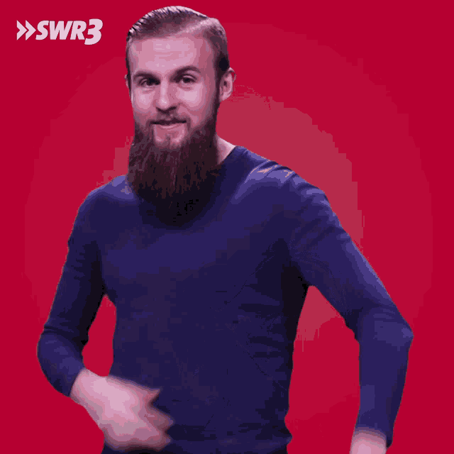a man with a beard is wearing a blue sweater with swr3 written on the bottom