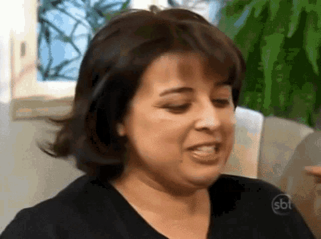 a woman wearing a black shirt with sbt on it