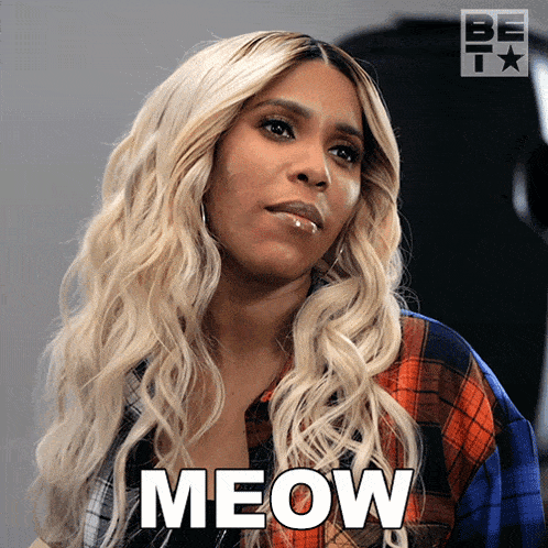 a woman in a plaid shirt has the word meow written on her face