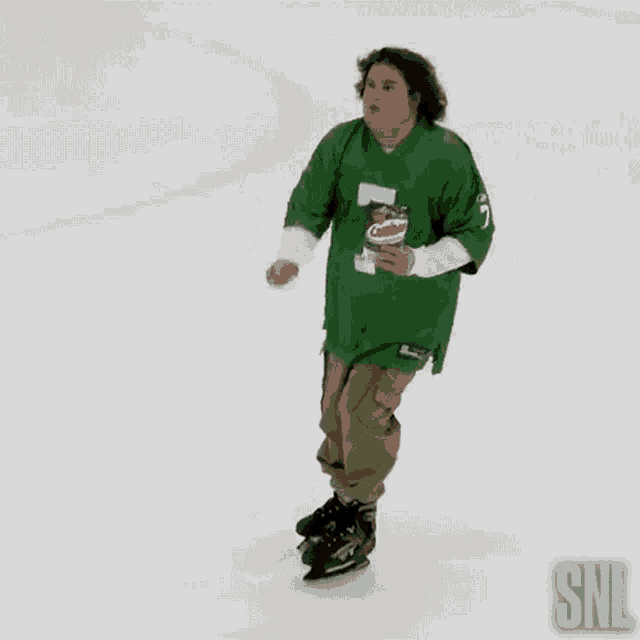 a man wearing a green pringles jersey is ice skating on a rink