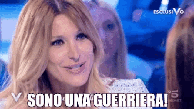 a close up of a woman 's face with the words sono una guerriera written above her .
