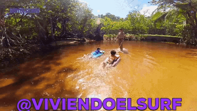 two people are swimming in a river with the words @viviendoelsurf written in purple