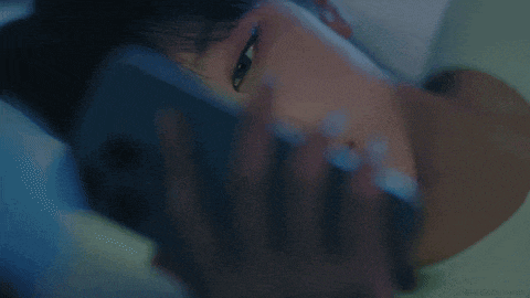 a close up of a woman 's face while sleeping in bed .