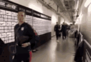 a blurry picture of a man walking down a hallway