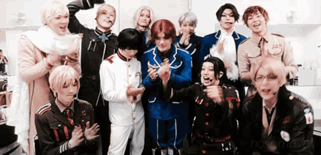 a group of people are posing for a picture and one of them has a badge on his chest that says ' adx '