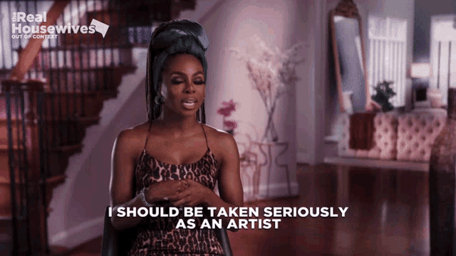 a woman in a leopard print dress is talking about being taken seriously as an artist