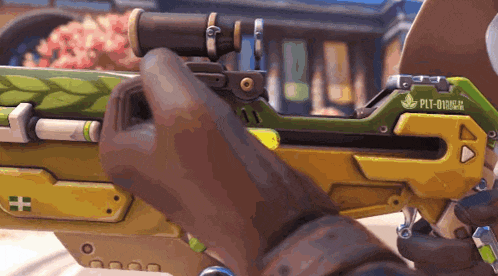 a person is holding a green and yellow sniper rifle with the letters plt-0 on it