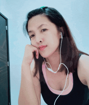 a woman wearing a black tank top and ear buds