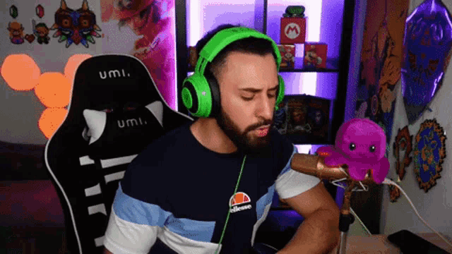 a man wearing green headphones and an ellesse shirt