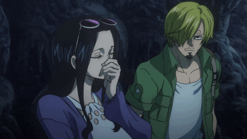 a man and a woman are standing next to each other in a dark cave
