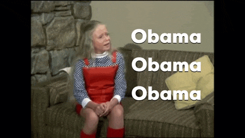 a little girl sits on a couch with obama obama obama