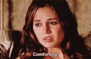 a woman is sitting in a chair and says comforting .
