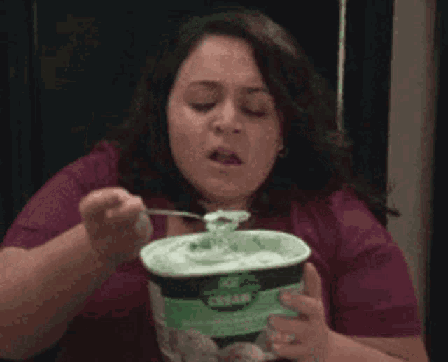 a woman is eating ice cream with a fork