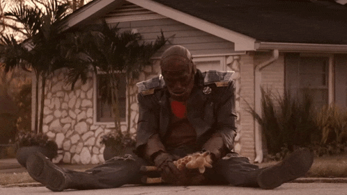 a man is sitting on the ground with his legs crossed