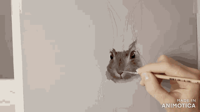 a person is painting a rabbit with a brush and the words made in animotica are visible on the bottom
