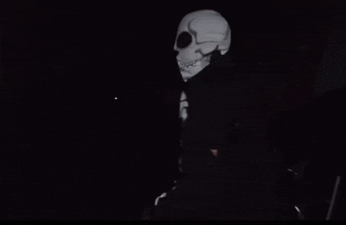 a skeleton is projected on a black surface in the dark .