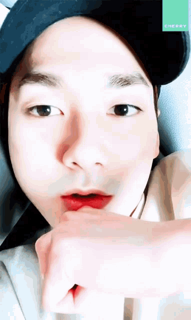 a close up of a person 's face with cherry written on the corner
