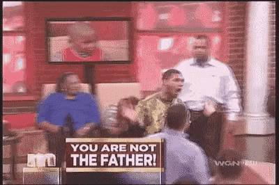 a group of people sitting in chairs with a sign that says `` you are not the father '' .