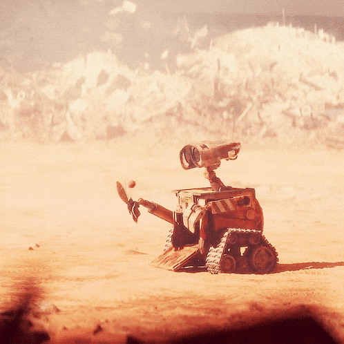 wall e is sitting in the middle of a desert