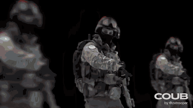 a blurred image of a group of people standing next to each other holding hands .