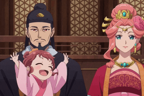 a man and a woman are holding a little girl