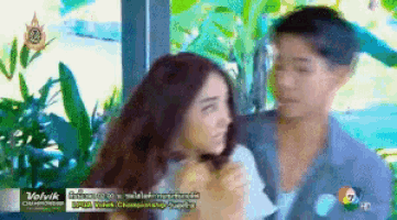 a man and a woman are standing next to each other on a tv screen with the words volvik on the bottom right