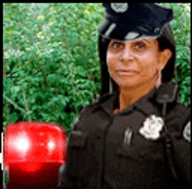 a police officer is standing in front of a red light