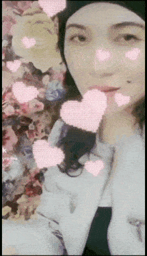a woman 's face is surrounded by pink hearts and flowers with the letter k on the bottom