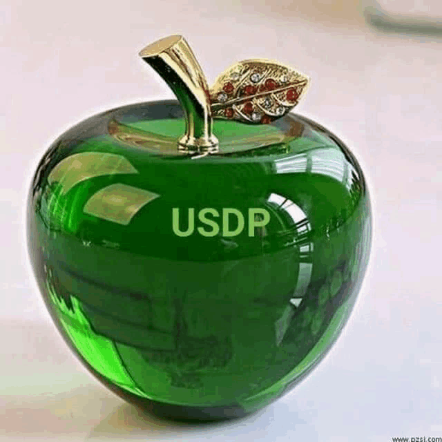 a green glass apple with the word usdr on it