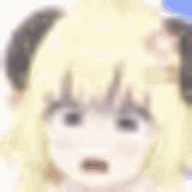 a blurry picture of a girl with yellow hair and horns .