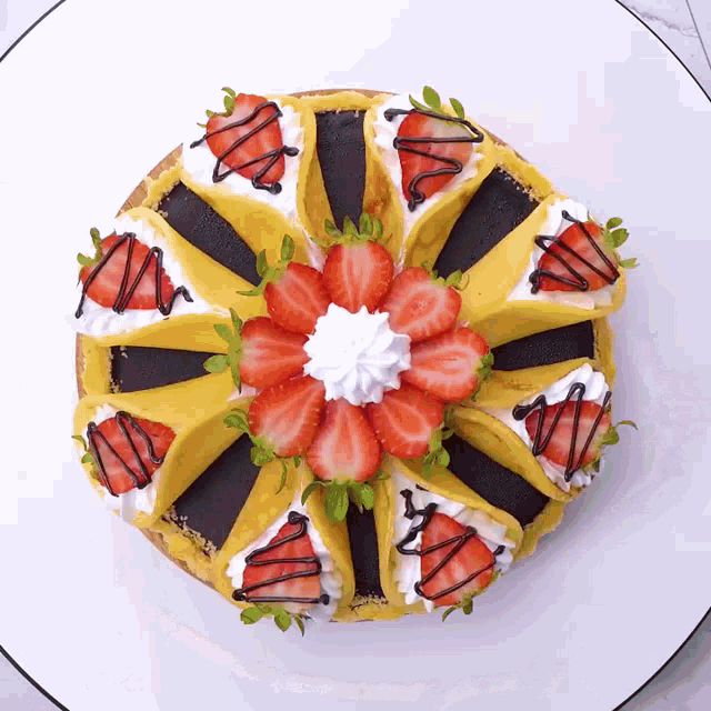 a cake with whipped cream and strawberries on it