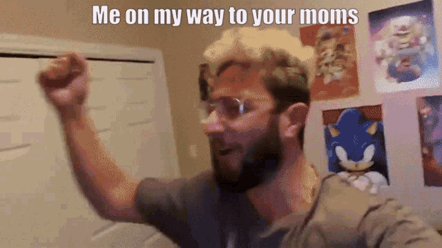 a man with a beard and glasses holds his fist up in the air with the caption me on my way to your moms