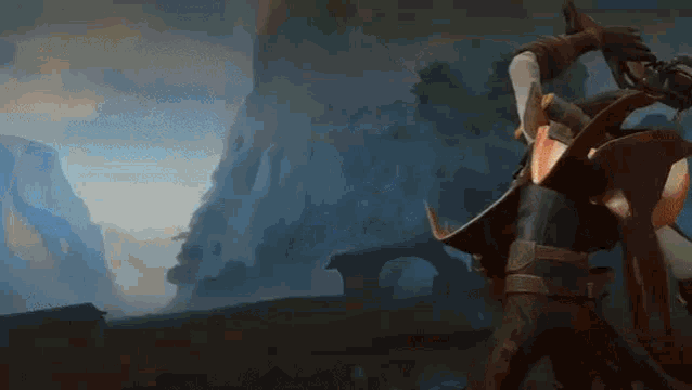 a man in a knight 's armor is standing in a field with mountains in the background .