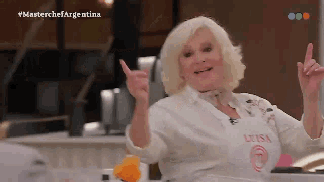 a woman wearing a white apron that says luisa