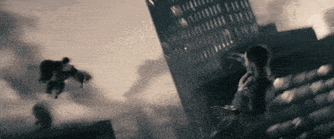 a man in a superman suit is flying over a building