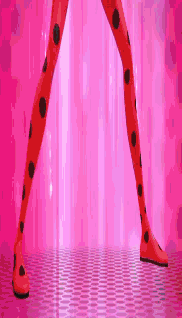 ladybug 's legs are shown with black polka dots on a pink background