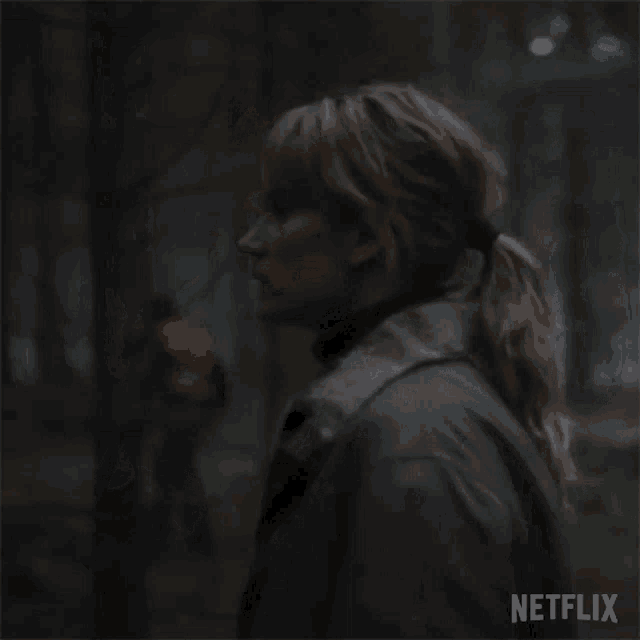 a woman in a fur coat and turtleneck is standing in a forest .