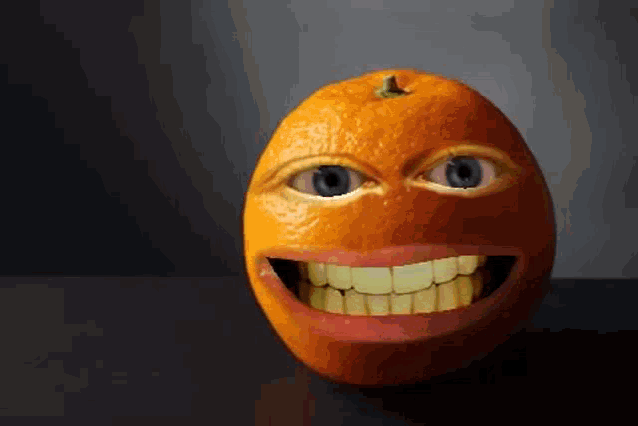 an orange with two eyes and a big smile on it 's face