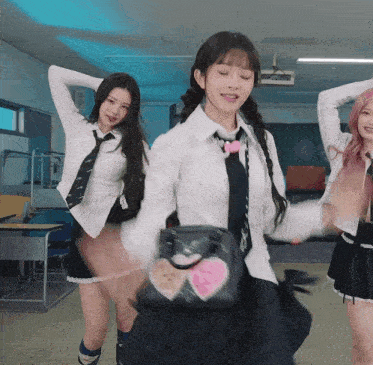 a girl in a school uniform is holding a bag with a heart on it